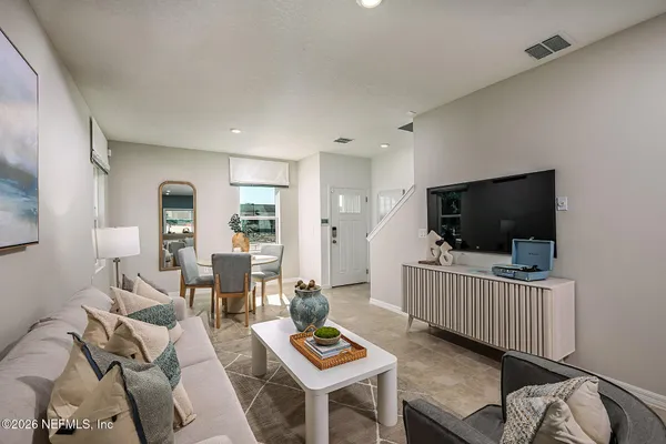 a living room with furniture and a flat screen tv