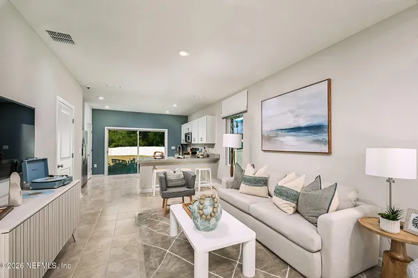 a dining room with furniture a window and a potted plant