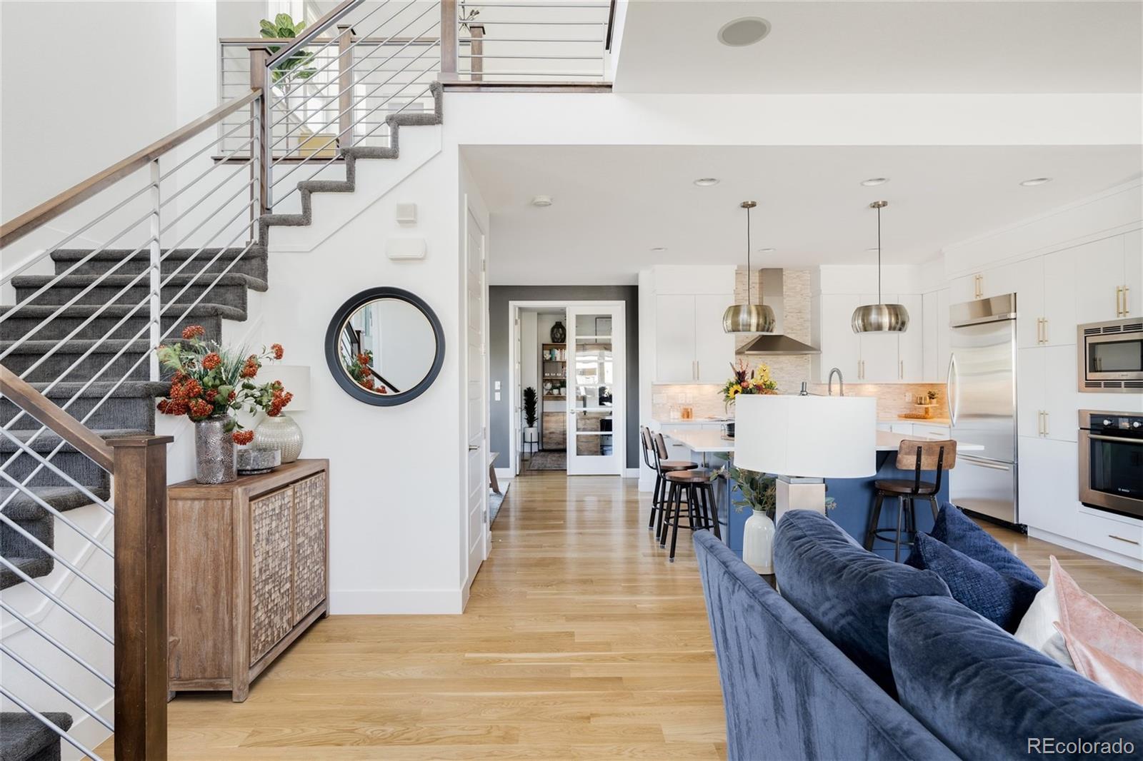 7790 East 32nd Avenue Denver, CO 80238 - Photo 12 of 40 a living room with furniture a wooden floor and a dining table