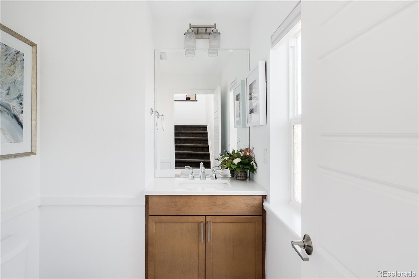 7790 East 32nd Avenue Denver, CO 80238 - Photo 14 of 40 a bathroom with a sink and mirror