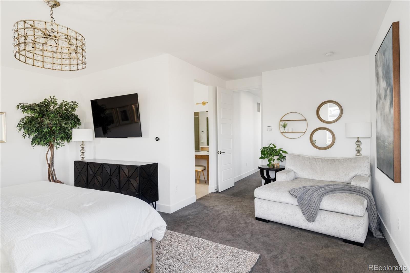 7790 East 32nd Avenue Denver, CO 80238 - Photo 17 of 40 a living room with furniture a flat screen tv and a large window