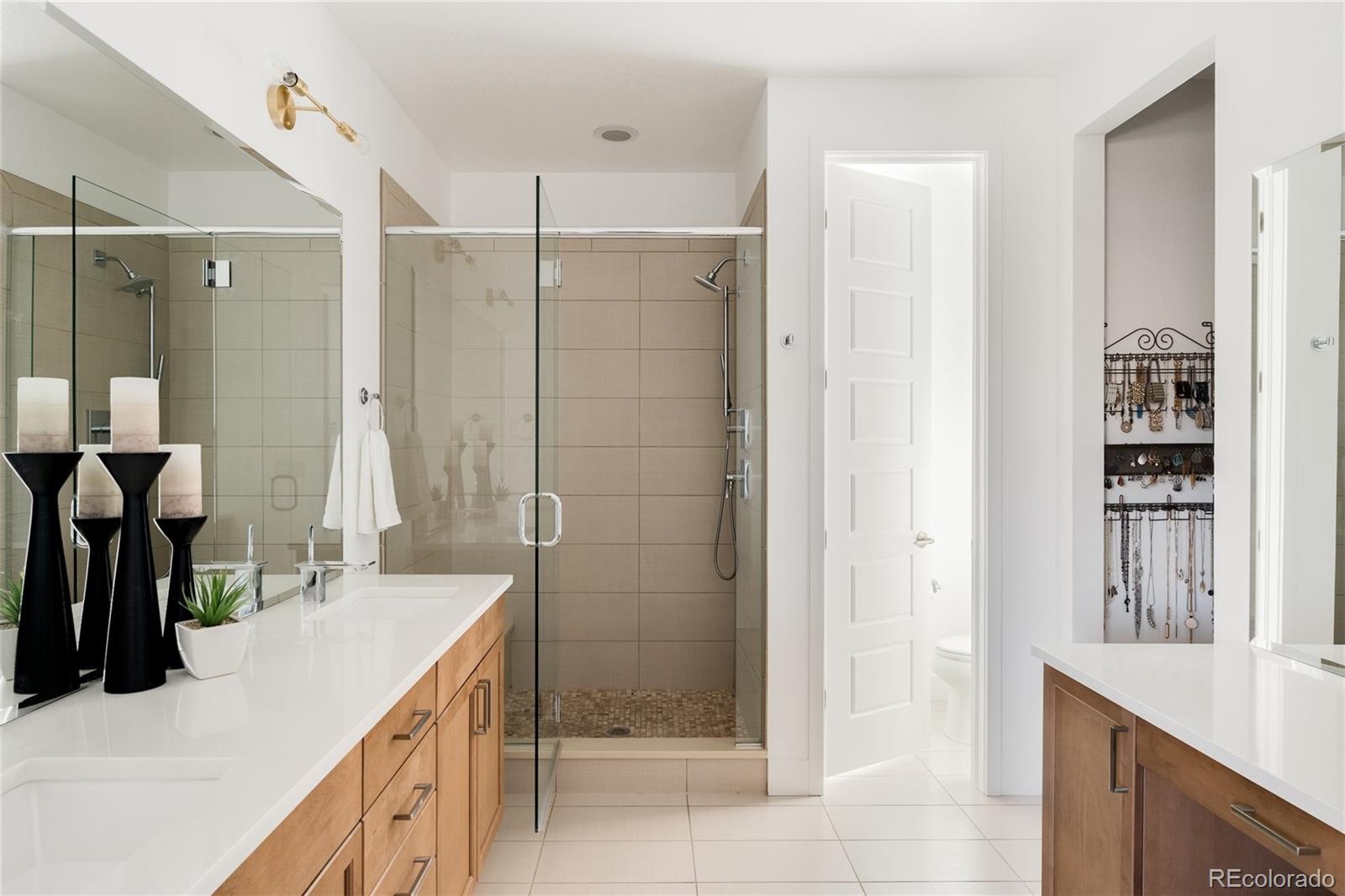 7790 East 32nd Avenue Denver, CO 80238 - Photo 18 of 40 a bathroom with a double vanity sink and a mirror