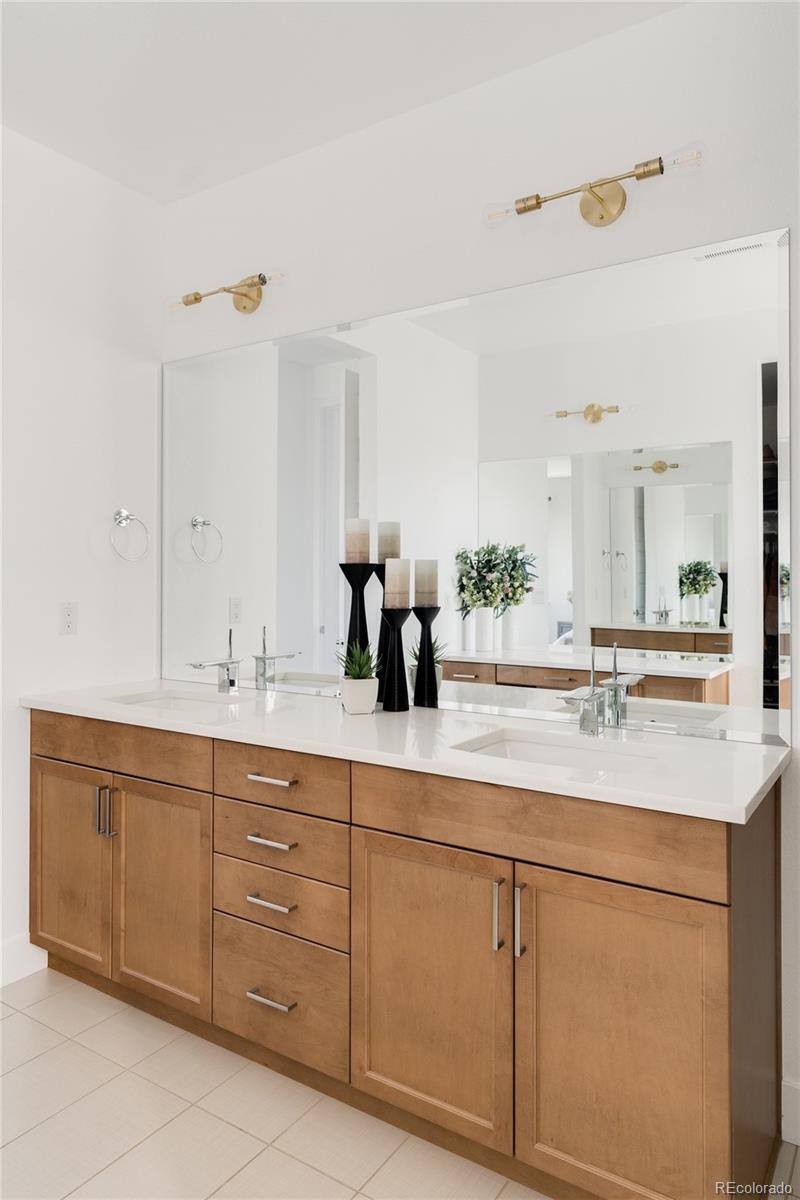 7790 East 32nd Avenue Denver, CO 80238 - Photo 19 of 40 a bathroom with a sink vanity and mirror