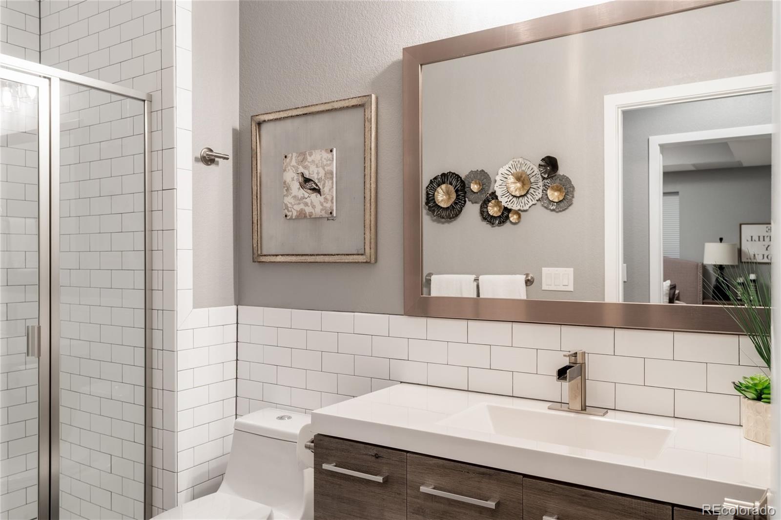7790 East 32nd Avenue Denver, CO 80238 - Photo 29 of 40 a bathroom with a sink and a mirror