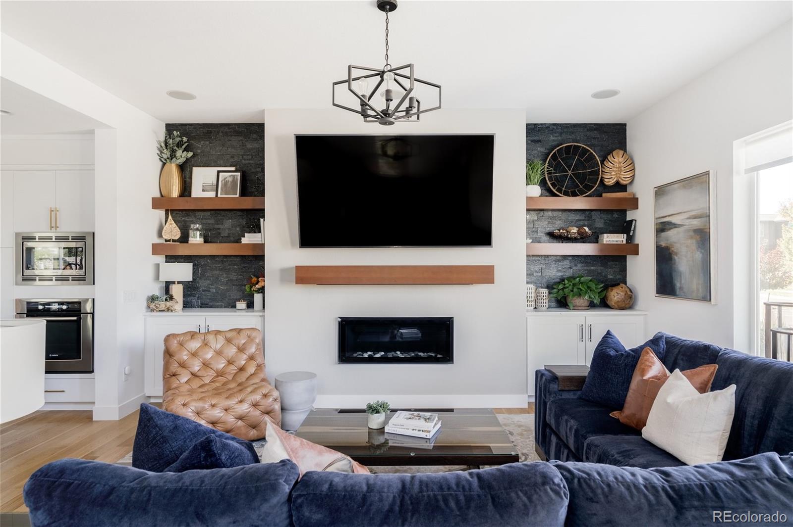 7790 East 32nd Avenue Denver, CO 80238 - Photo 3 of 40 a living room with furniture a flat screen tv and a fireplace