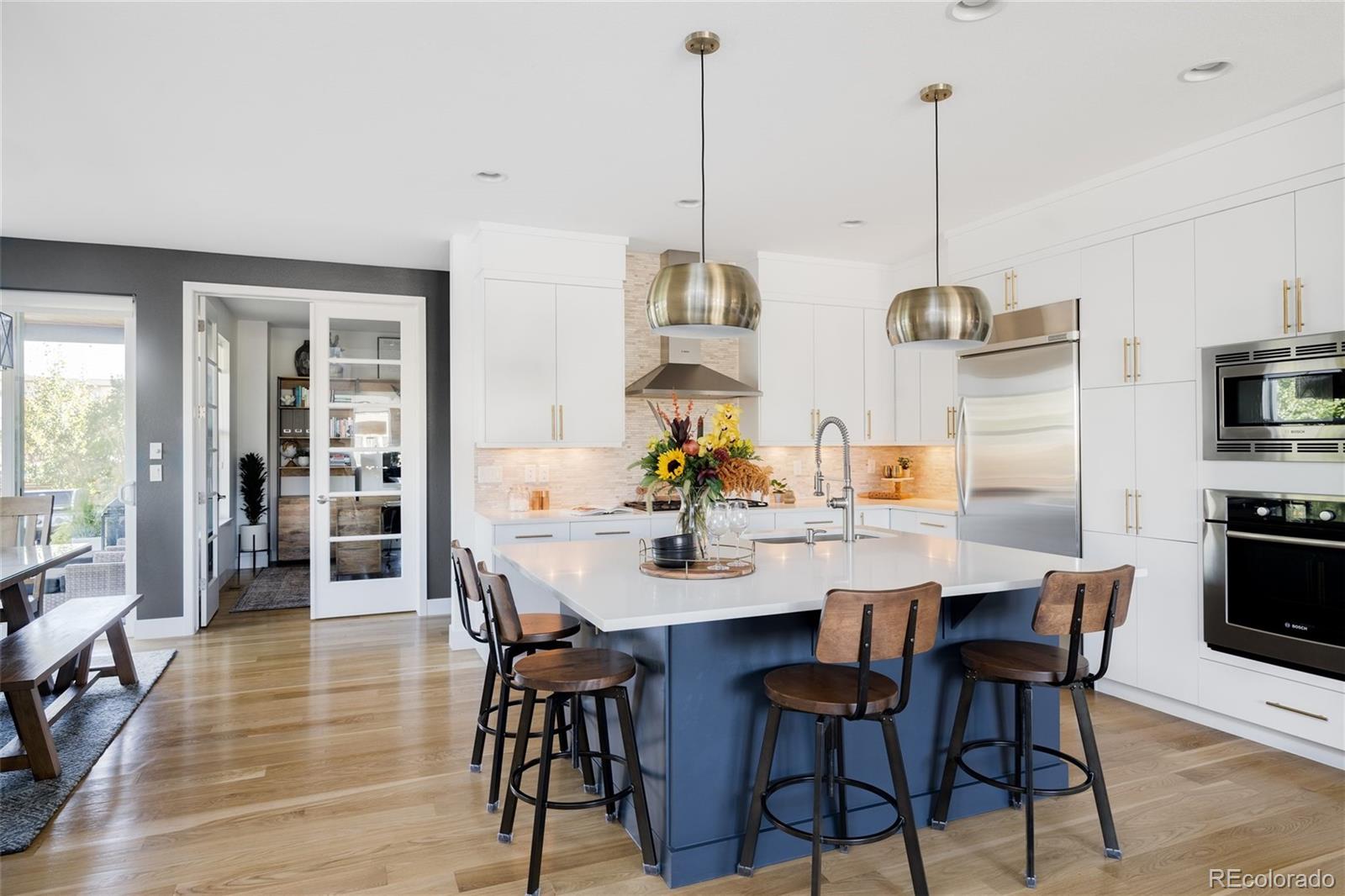 7790 East 32nd Avenue Denver, CO 80238 - Photo 5 of 40 a dining room with furniture a chandelier and wooden floor