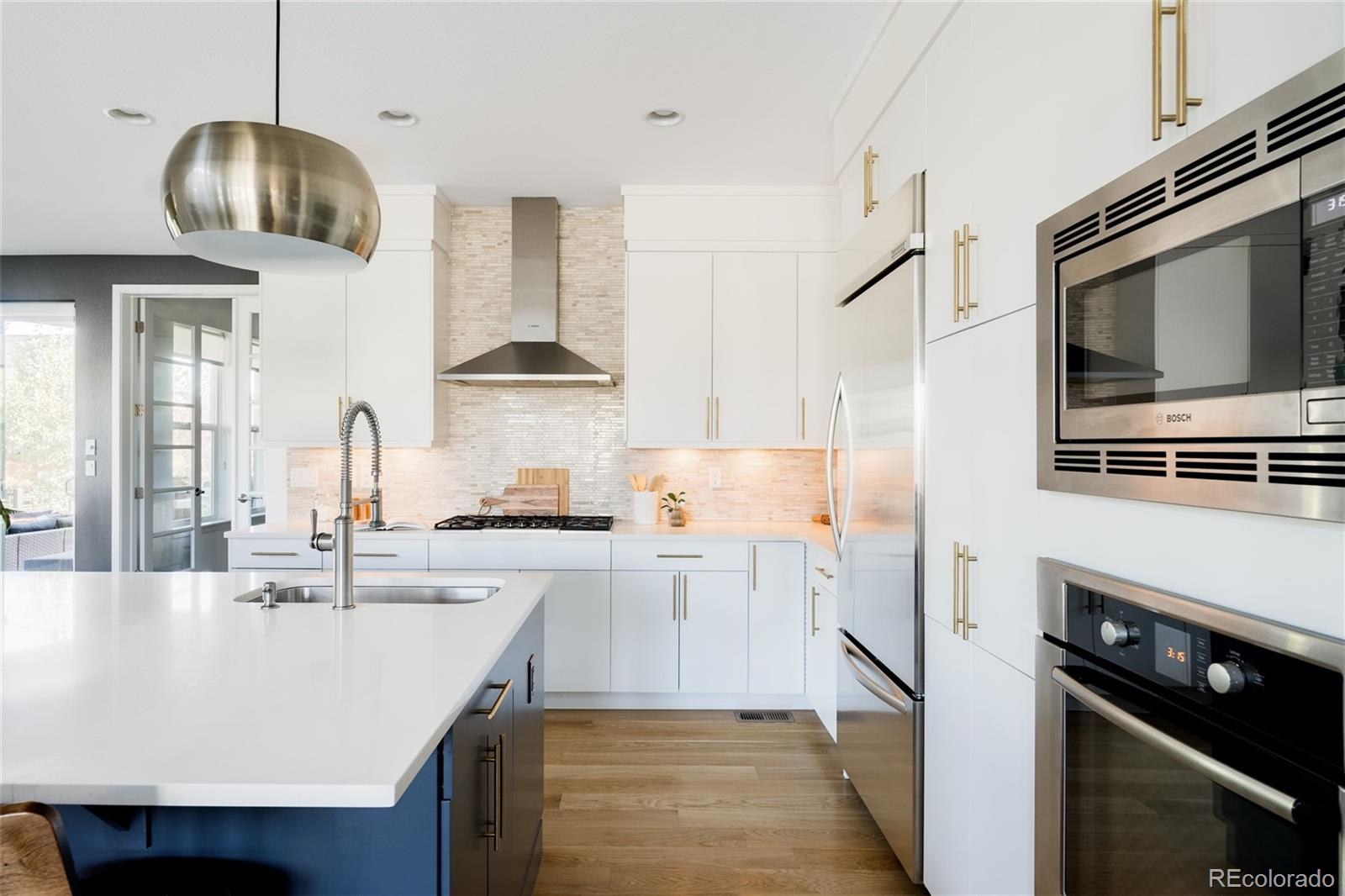 7790 East 32nd Avenue Denver, CO 80238 - Photo 6 of 40 a kitchen with stainless steel appliances a stove a sink and cabinets
