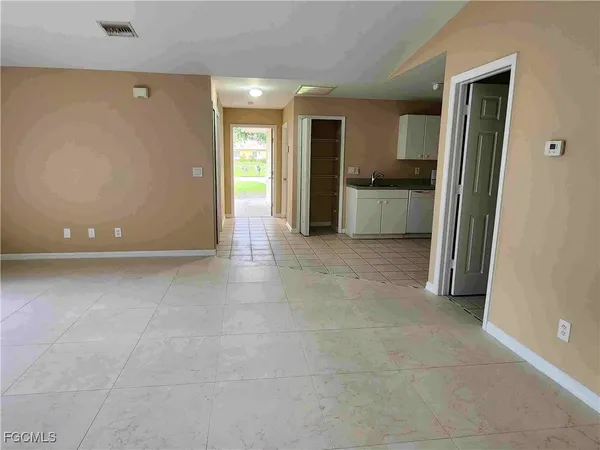 a front view of a house with a garden and trees