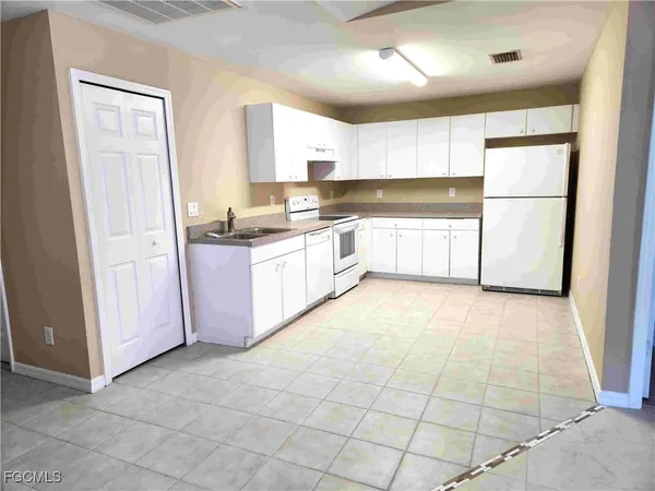 a large kitchen with granite countertop a stove a sink and a refrigerator