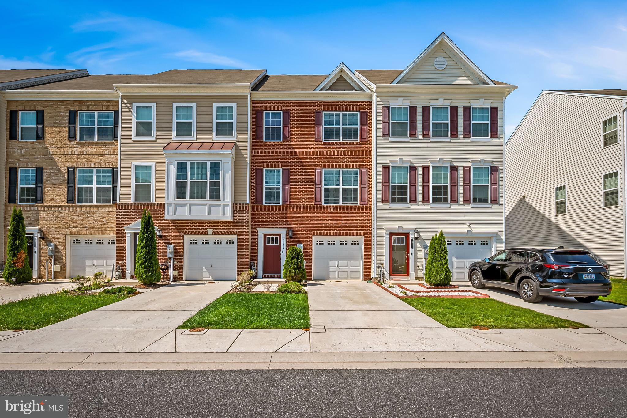 a front view of a residential apartment building with a yard