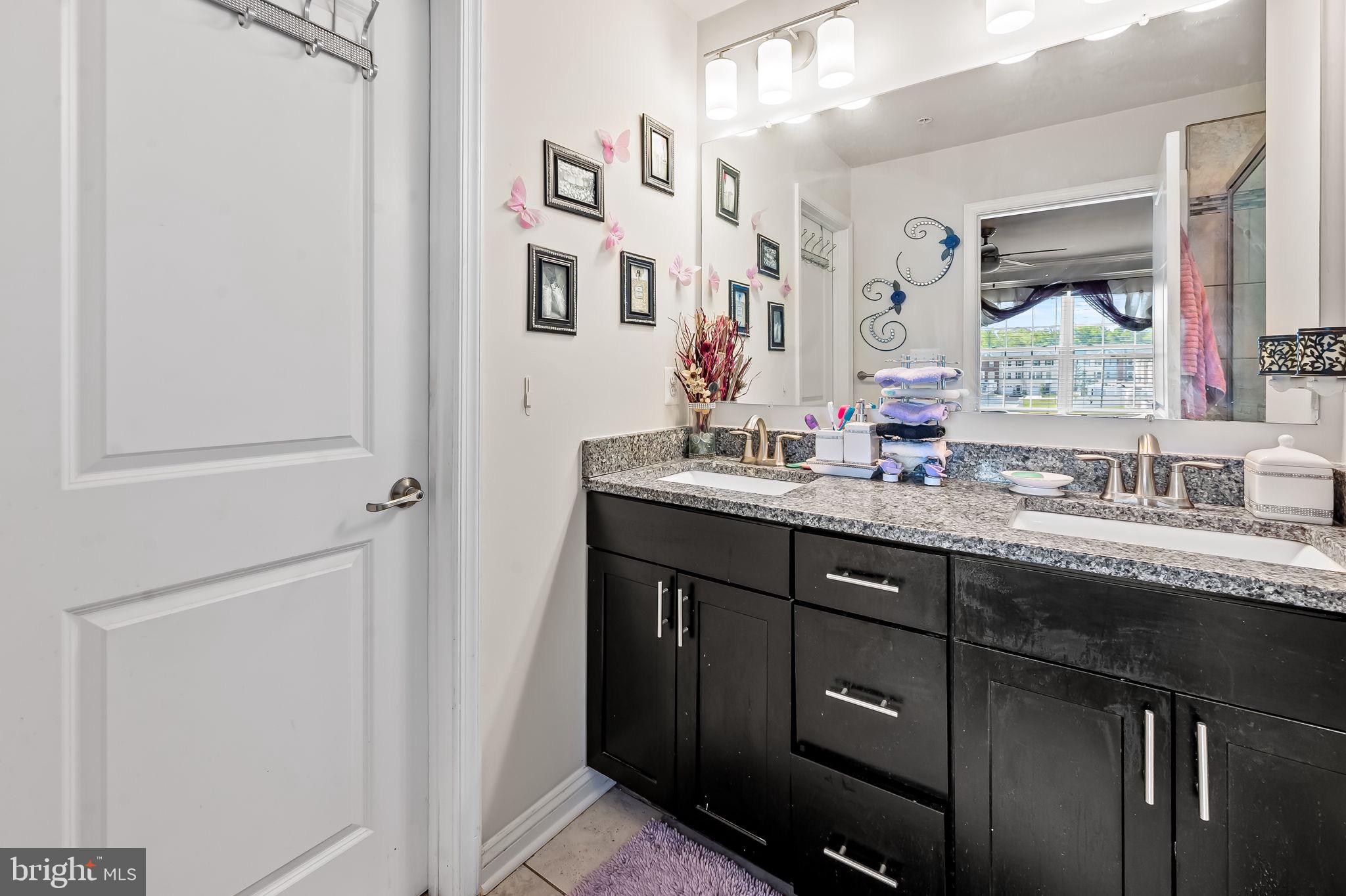 1309 Spindrift Road Aberdeen, MD 21001 - Photo 23 of 35 a bathroom with a double vanity sink and a mirror
