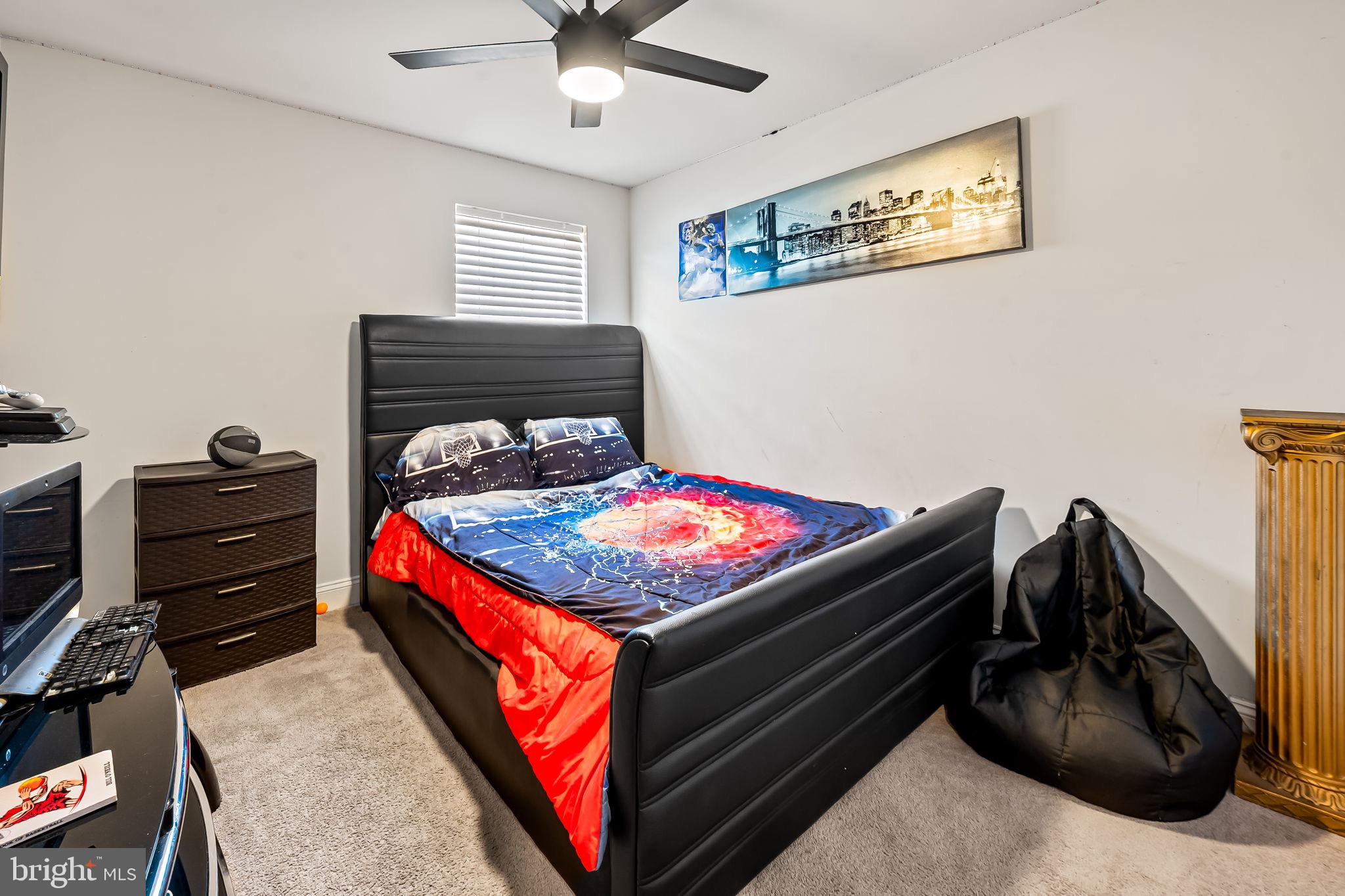 1309 Spindrift Road Aberdeen, MD 21001 - Photo 27 of 35 a bedroom with a bed and a chandelier