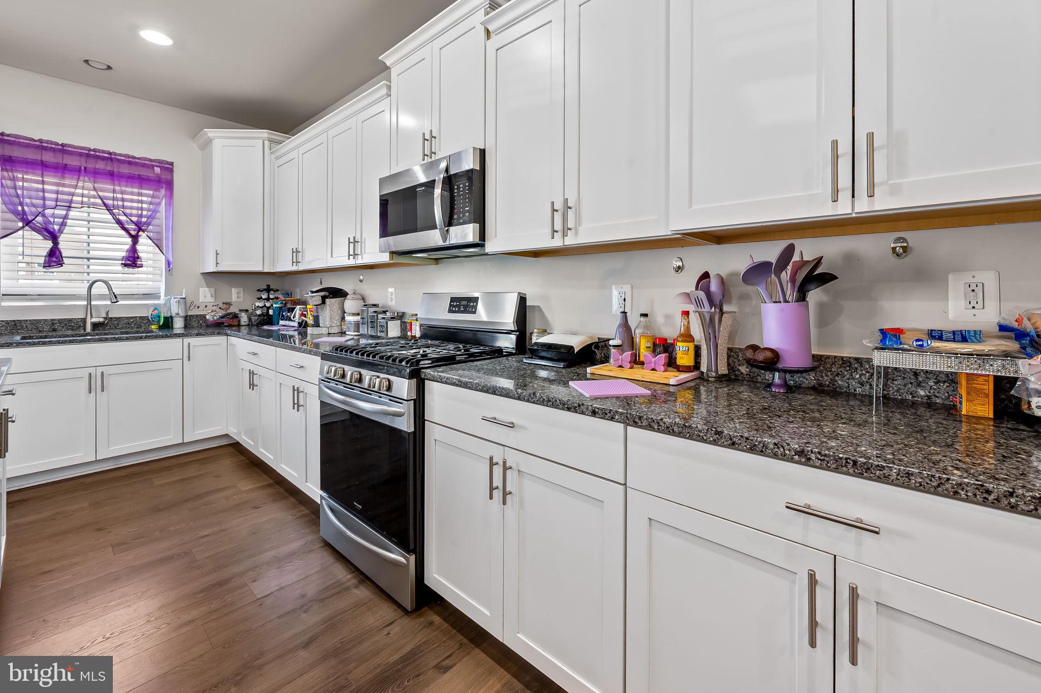 1309 Spindrift Road Aberdeen, MD 21001 - Photo 7 of 35 a kitchen with stainless steel appliances granite countertop a sink a stove and cabinets