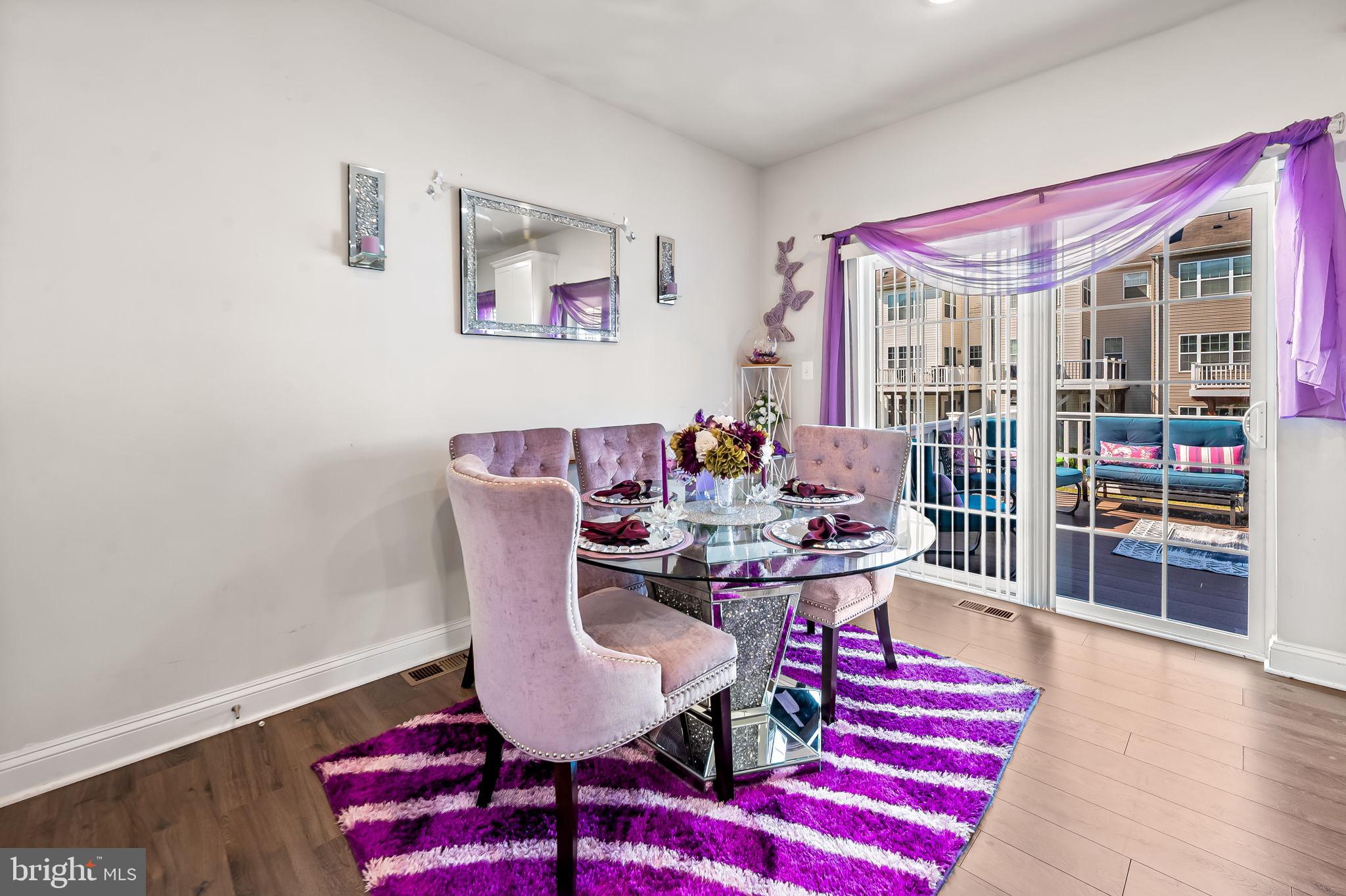 1309 Spindrift Road Aberdeen, MD 21001 - Photo 10 of 35 a dining room with furniture a rug and wooden floor