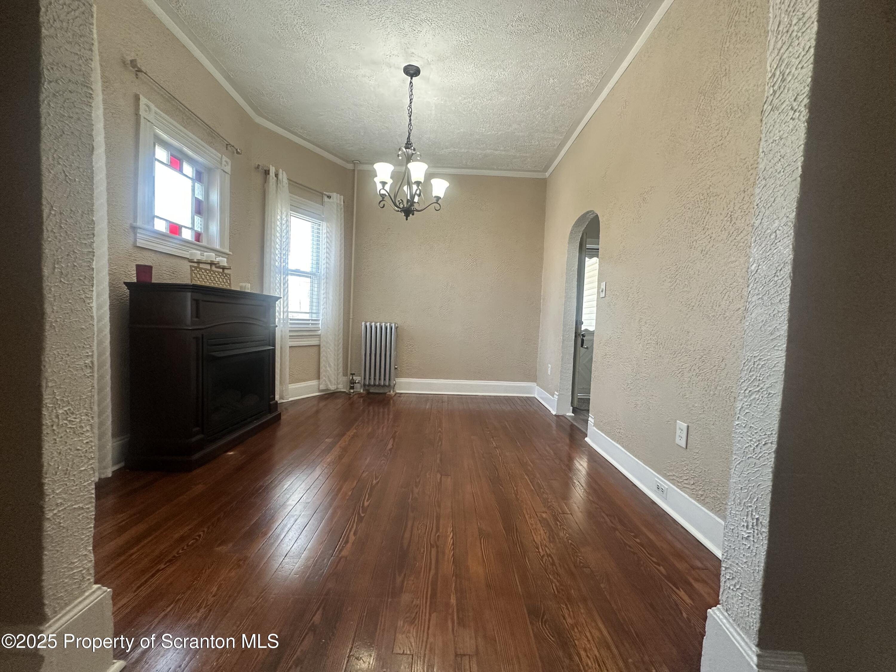 821 Maple Street Scranton, PA 18505 - Photo 4 of 21 an empty room with wooden floor chandelier and entryway