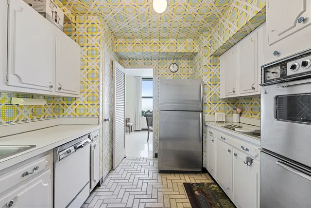 a kitchen with stainless steel appliances a refrigerator sink and cabinets