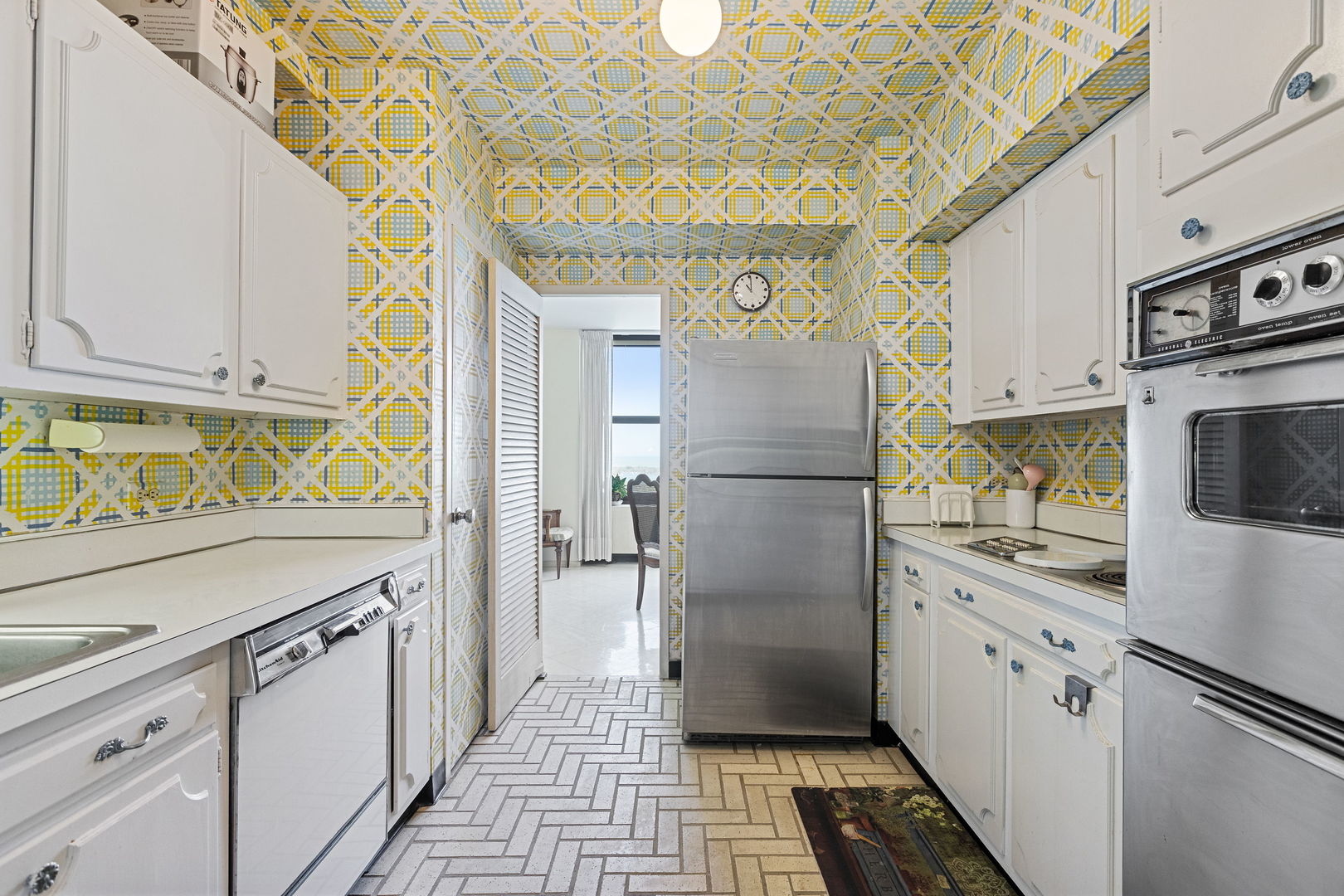 3150 North Lake Shore Drive, Unit 30C Chicago, IL 60657 - Photo 12 of 41 a kitchen with stainless steel appliances a refrigerator sink and cabinets