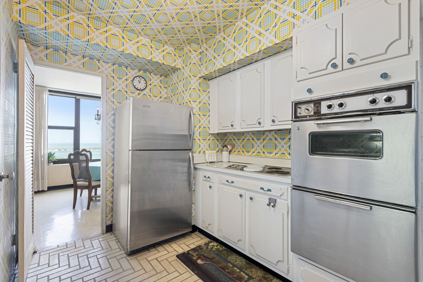 3150 North Lake Shore Drive, Unit 30C Chicago, IL 60657 - Photo 13 of 41 a white refrigerator freezer and a stove sitting inside of a kitchen