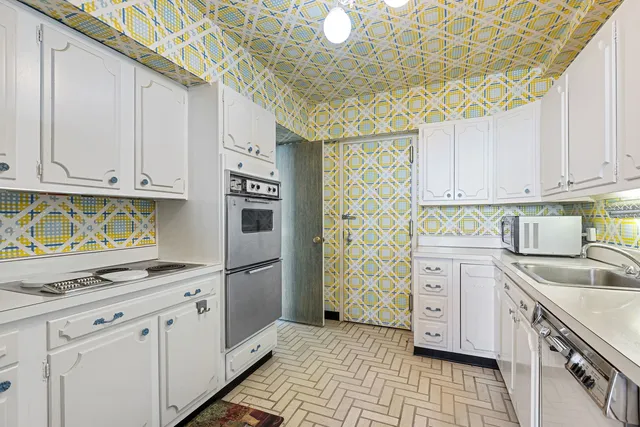 a kitchen with stainless steel appliances granite countertop a sink stove and cabinets