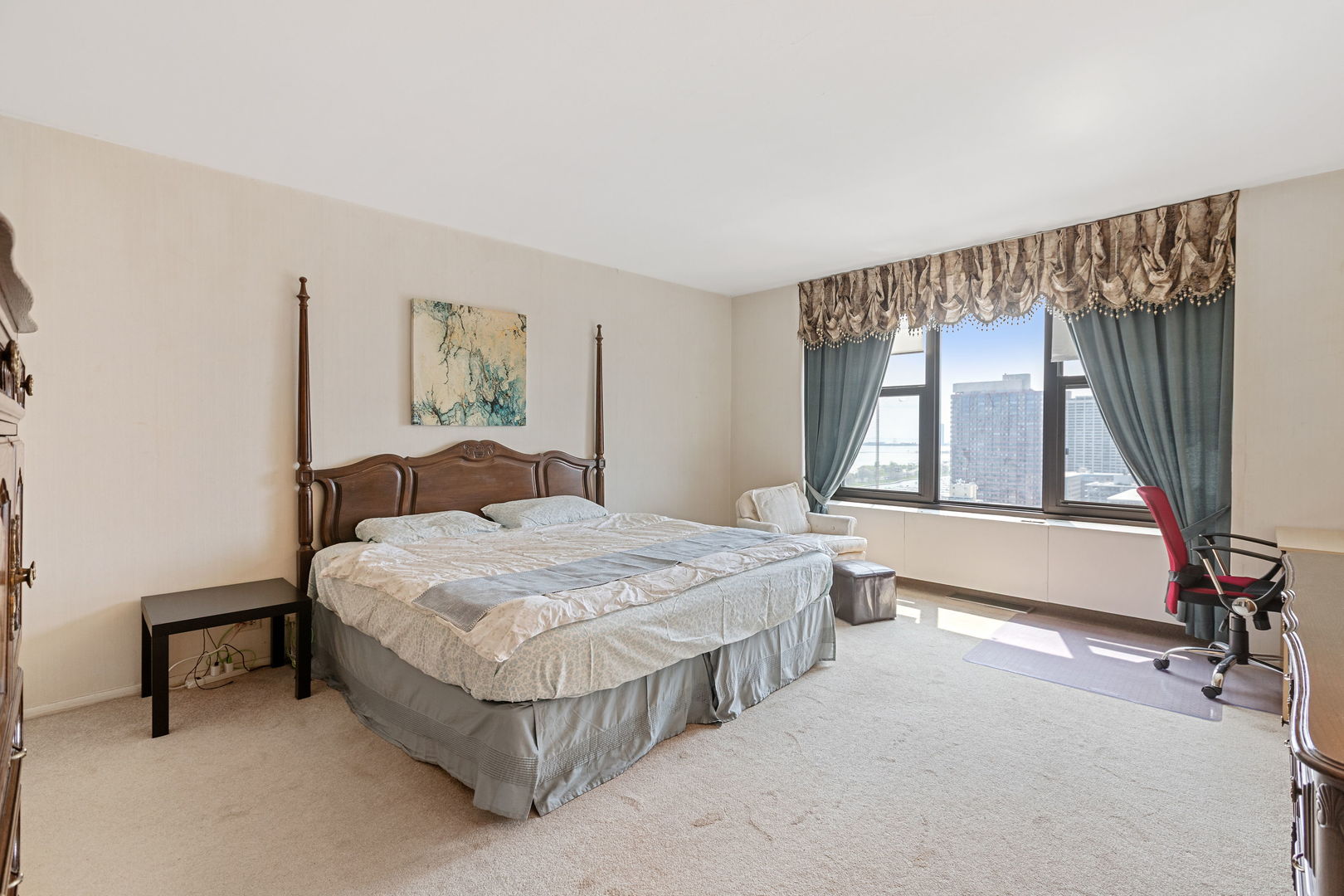 3150 North Lake Shore Drive, Unit 30C Chicago, IL 60657 - Photo 15 of 41 a bedroom with a bed a mirror and a large window