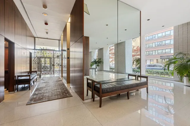 a large living room with large windows and furniture