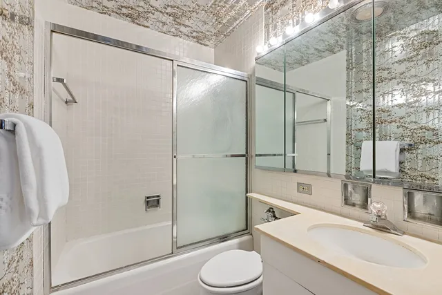 a bathroom with a sink toilet and shower