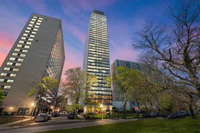 a front view of a multi story building with yard