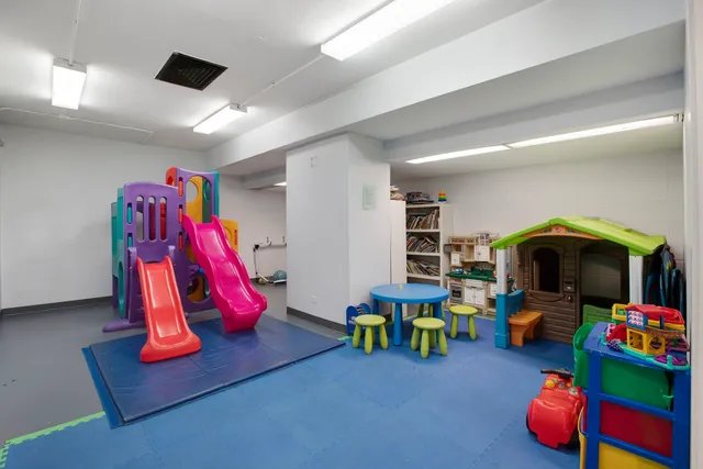 a living room with furniture and gym equipment
