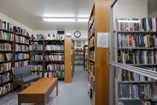 a view of a livingroom with furniture and a bookshelf