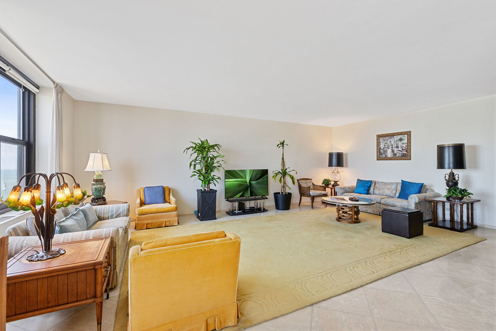 3150 North Lake Shore Drive, Unit 30C Chicago, IL 60657 - Photo 9 of 41 a living room with furniture a flat screen tv and a potted plant