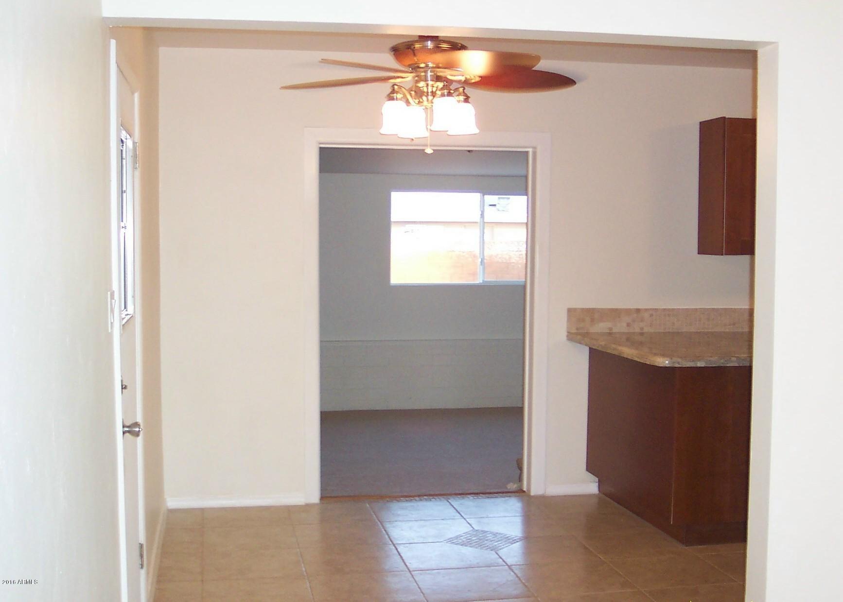 4415 East Coronado Road Phoenix, AZ 85008 - Photo 4 of 7 eat in area of kitchen looking into fami