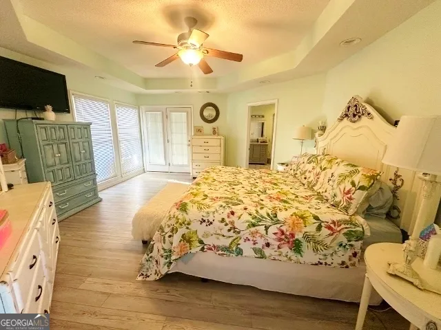 a bed sitting in a spacious bedroom next to a window