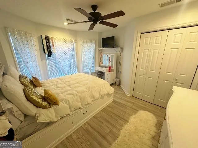 a bed sitting in a bedroom next to a window