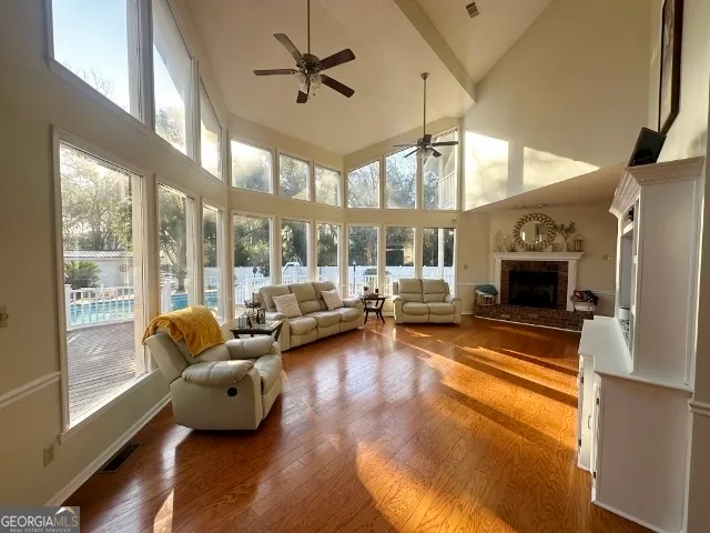 a living room with furniture fireplace and a large window
