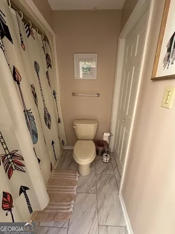 a bathroom with a toilet and a shower