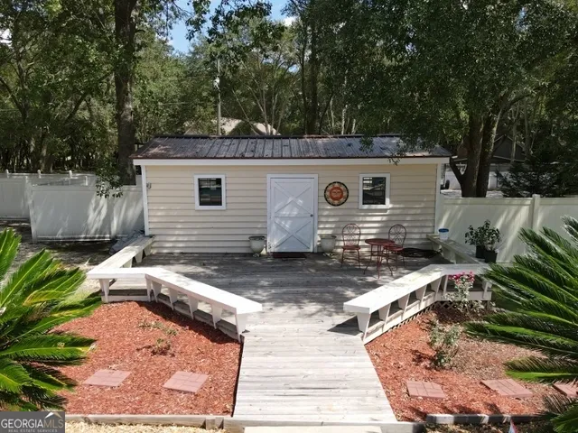 a view of a backyard with a sitting area