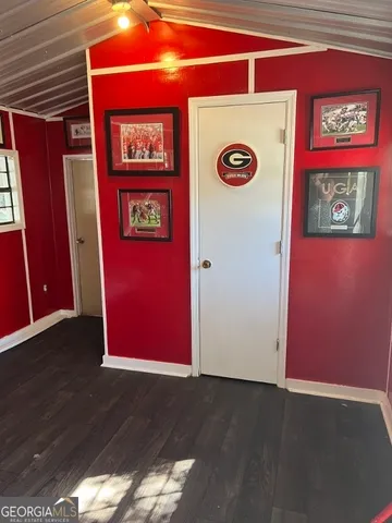 a white toilet sitting next to a small white wall