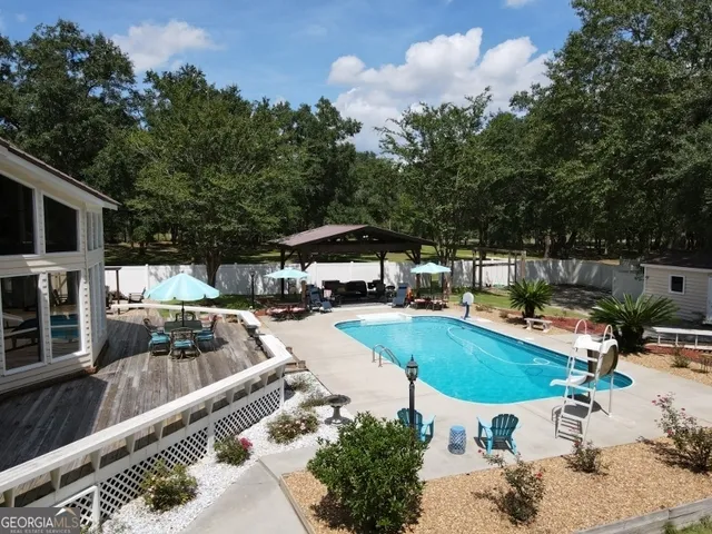 a roof deck with table and chairs and potted plants