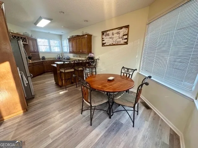 a view of a dining room with furniture window and wooden floor