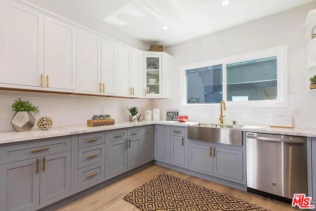 2419 Walnut Avenue Venice, CA 90291 - Photo 5 of 16 a kitchen with granite countertop white cabinets and white appliances