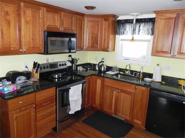 1349 Trapelo Road Waltham, MA 02451 - Photo 3 of 16 a kitchen with granite countertop a sink cabinets and stainless steel appliances