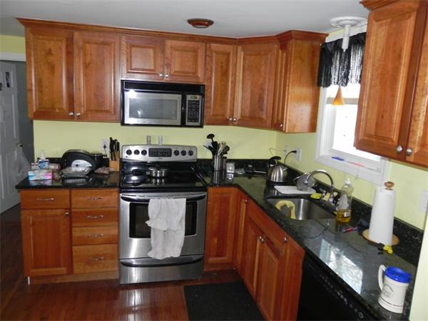 1349 Trapelo Road Waltham, MA 02451 - Photo 4 of 16 a kitchen with stainless steel appliances granite countertop a stove a sink and a microwave