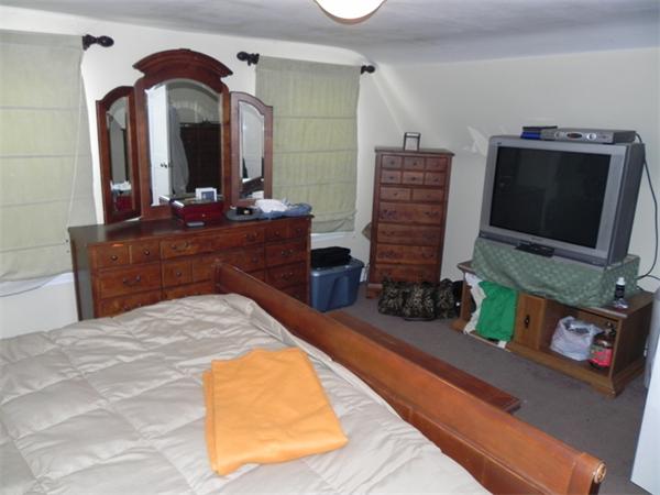 1349 Trapelo Road Waltham, MA 02451 - Photo 10 of 16 a bedroom with a bed and a flat screen tv