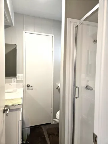 a bathroom with a shower and a sink