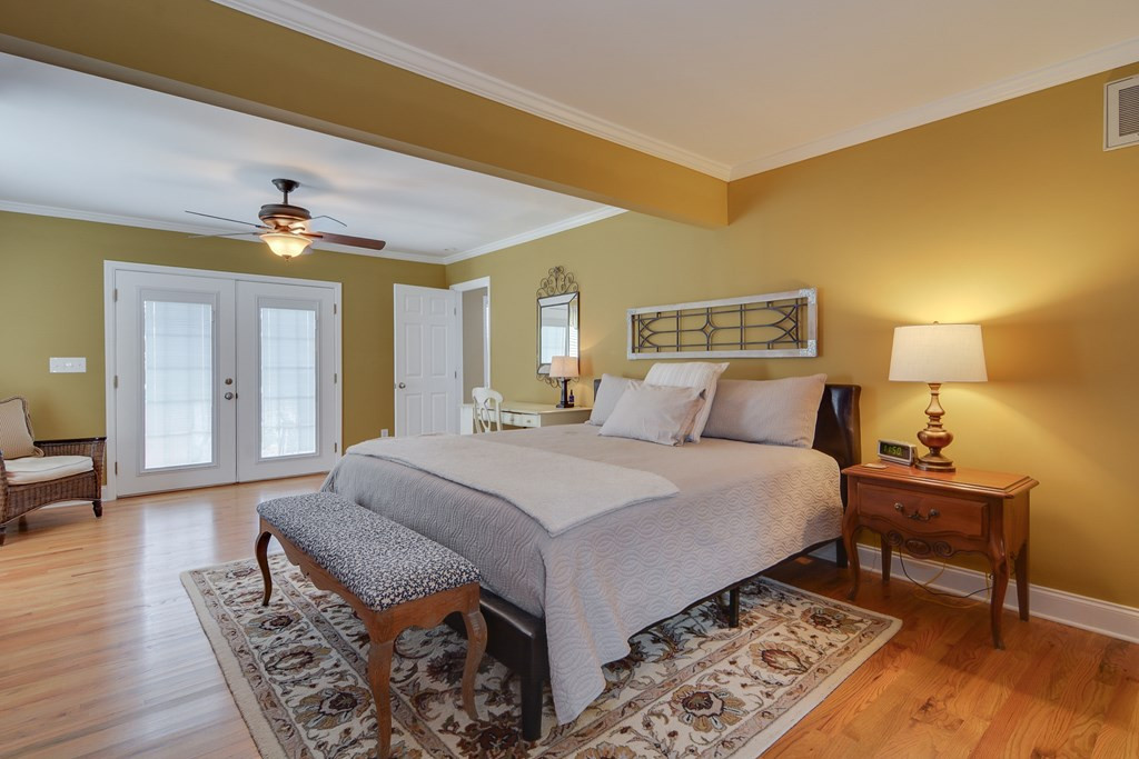 388 W Road Aiken, SC 29801 - Photo 11 of 32 a spacious bedroom with a bed and wooden floor