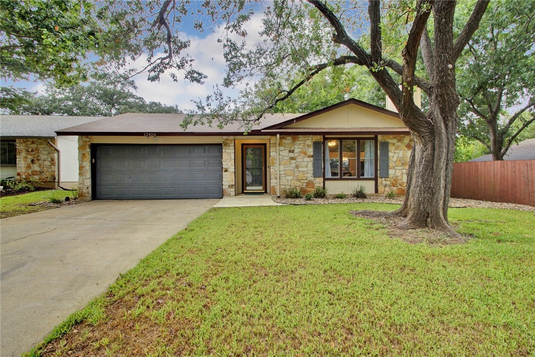 12420 Turtleback Lane Austin, TX 78727 - Photo 1 of 1 a front view of a house with garden