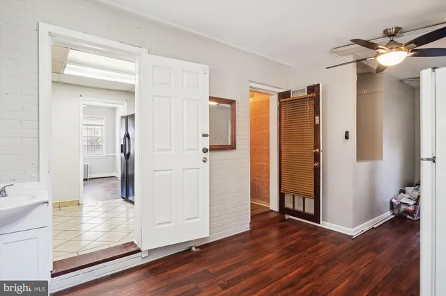 a view of a hallway with wooden floor and closet