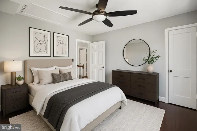 a bedroom with a bed a mirror and a window