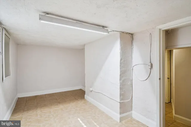 a view of a room with wooden floor and cabinet