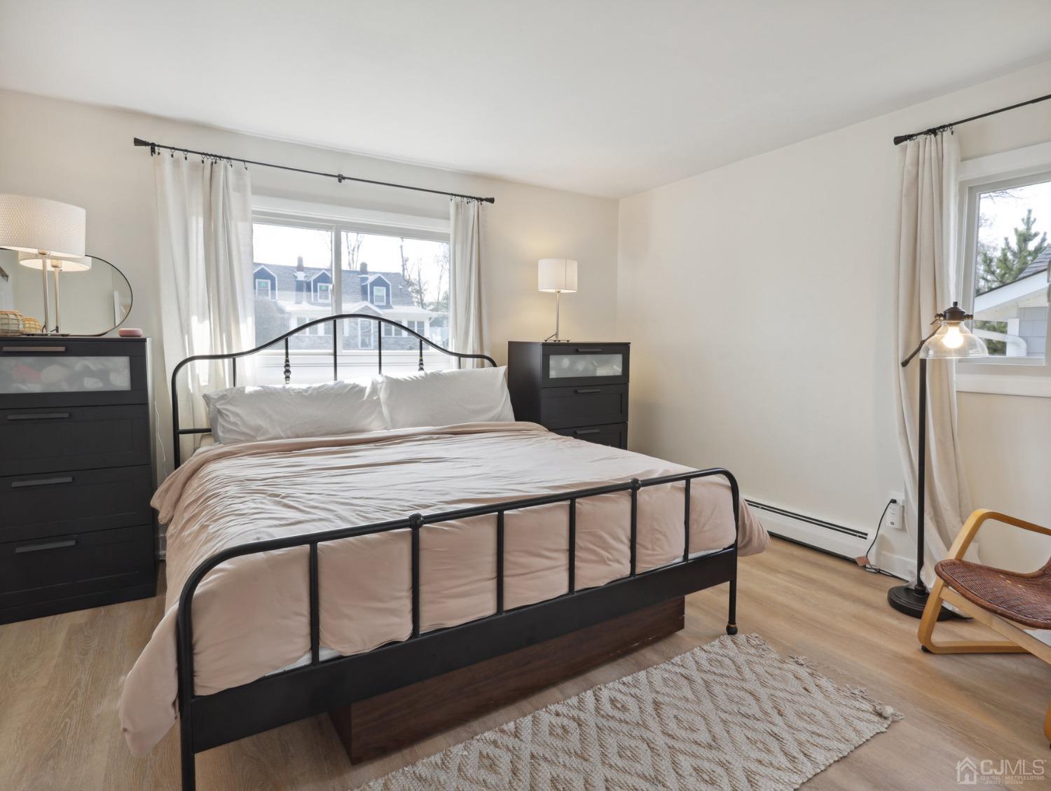 82 Normandy Road Colonia, NJ 07067 - Photo 15 of 33 a bedroom with a bed and wooden floor